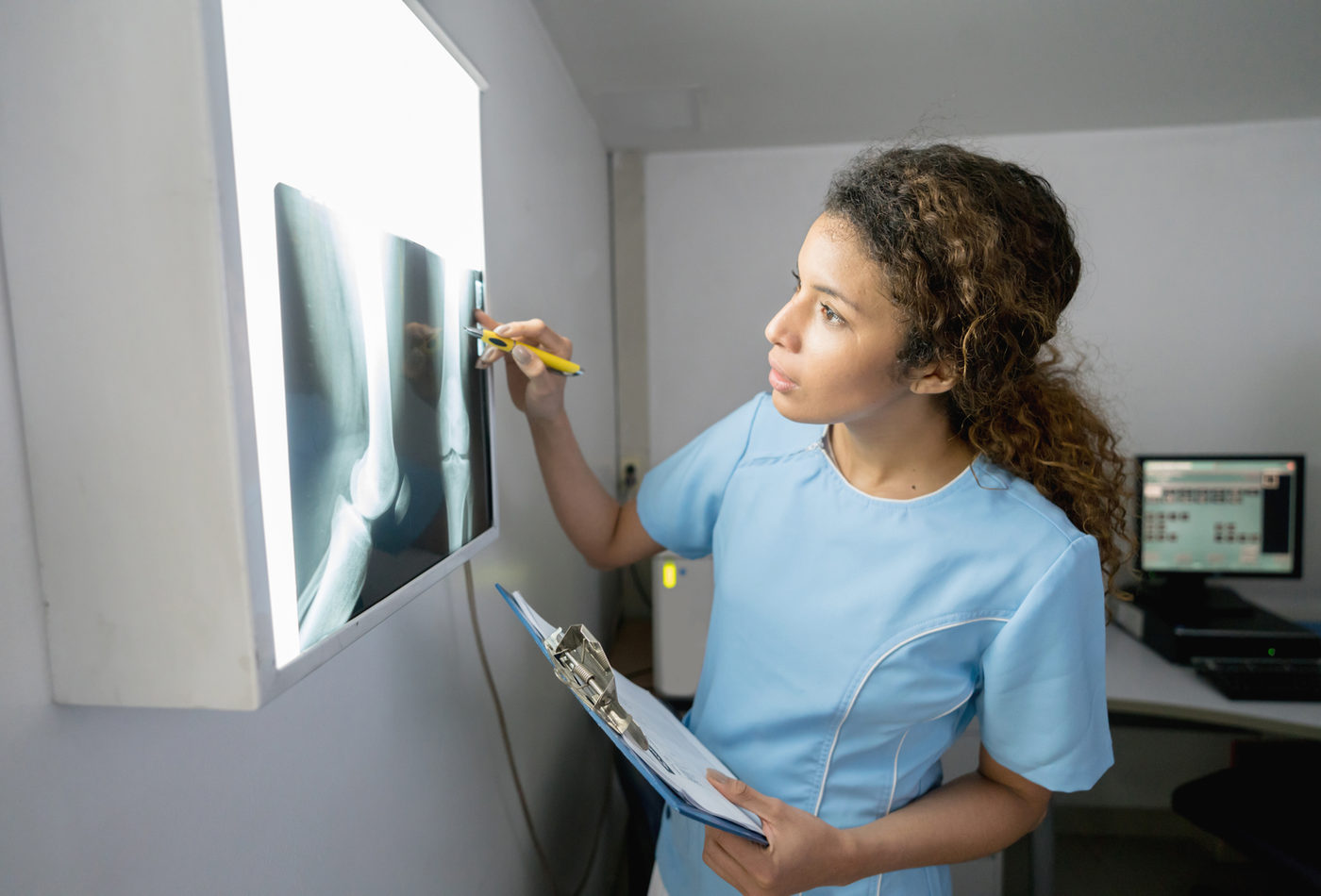 Healthcare professional examining an X-ray